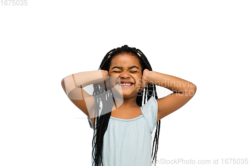 Image of Happy longhair brunette little girl isolated on white studio background. Looks happy, cheerful, sincere. Copyspace. Childhood, education, emotions concept