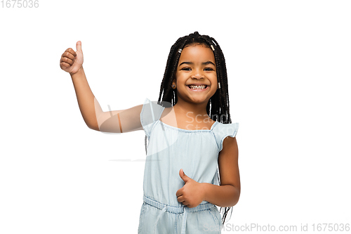 Image of Happy longhair brunette little girl isolated on white studio background. Looks happy, cheerful, sincere. Copyspace. Childhood, education, emotions concept