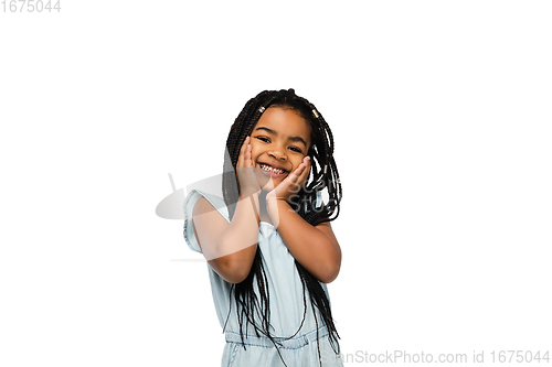 Image of Happy longhair brunette little girl isolated on white studio background. Looks happy, cheerful, sincere. Copyspace. Childhood, education, emotions concept