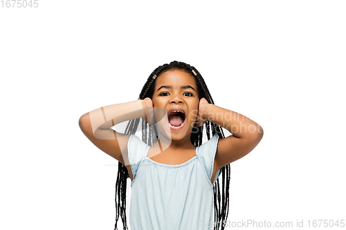 Image of Happy longhair brunette little girl isolated on white studio background. Looks happy, cheerful, sincere. Copyspace. Childhood, education, emotions concept
