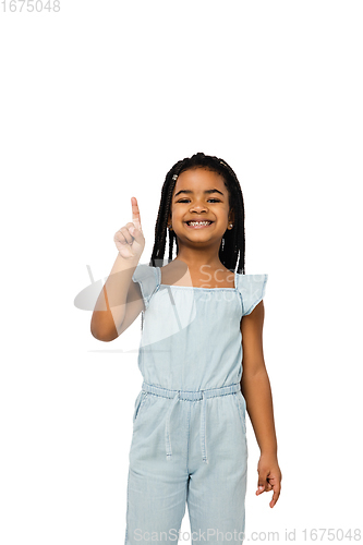 Image of Happy longhair brunette little girl isolated on white studio background. Looks happy, cheerful, sincere. Copyspace. Childhood, education, emotions concept