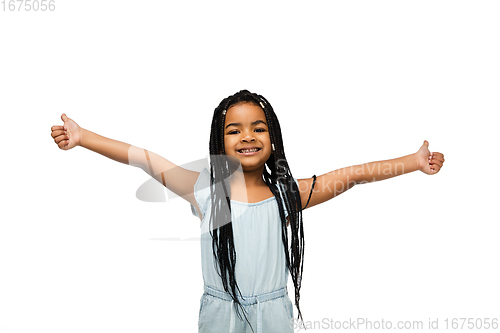 Image of Happy longhair brunette little girl isolated on white studio background. Looks happy, cheerful, sincere. Copyspace. Childhood, education, emotions concept