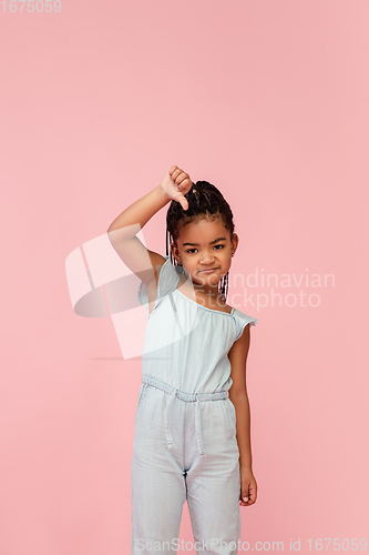 Image of Happy longhair brunette little girl isolated on pink studio background. Looks happy, cheerful, sincere. Copyspace. Childhood, education, emotions concept