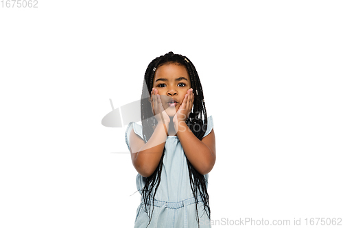 Image of Happy longhair brunette little girl isolated on white studio background. Looks happy, cheerful, sincere. Copyspace. Childhood, education, emotions concept