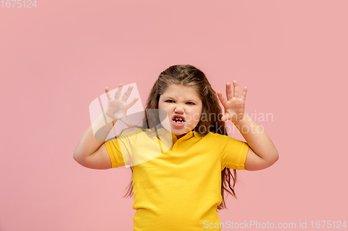 Image of Happy caucasian little girl isolated on studio background. Looks happy, cheerful, sincere. Copyspace. Childhood, education, emotions concept