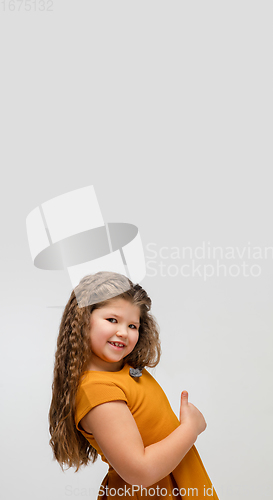 Image of Happy caucasian little girl isolated on studio background. Looks happy, cheerful, sincere. Copyspace. Childhood, education, emotions concept