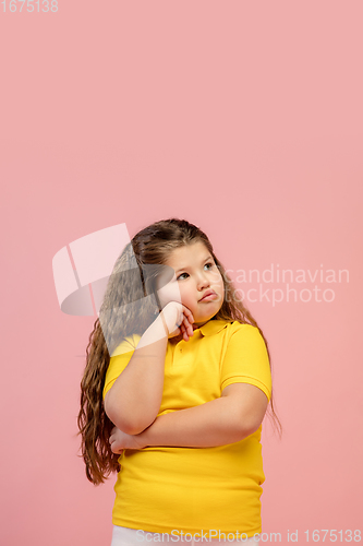 Image of Happy caucasian little girl isolated on studio background. Looks happy, cheerful, sincere. Copyspace. Childhood, education, emotions concept