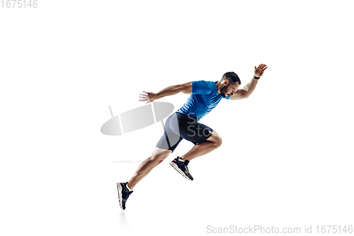 Image of Caucasian professional male runner, athlete training isolated on white studio background. Copyspace for ad.