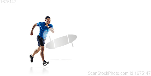 Image of Caucasian professional male runner, athlete training isolated on white studio background. Copyspace for ad.