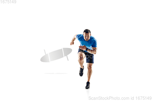 Image of Caucasian professional male runner, athlete training isolated on white studio background. Copyspace for ad.