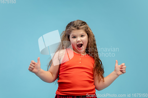 Image of Happy caucasian little girl isolated on studio background. Looks happy, cheerful, sincere. Copyspace. Childhood, education, emotions concept