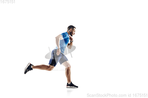 Image of Caucasian professional male runner, athlete training isolated on white studio background. Copyspace for ad.