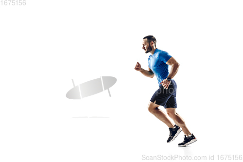 Image of Caucasian professional male runner, athlete training isolated on white studio background. Copyspace for ad.