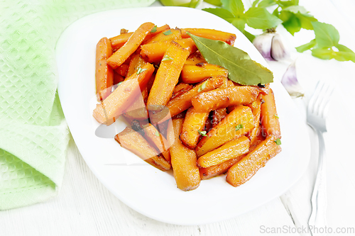 Image of Carrots fried in plate on wooden board
