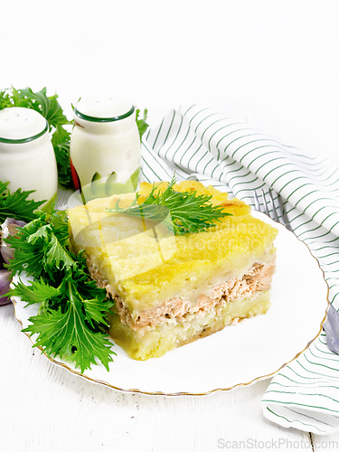 Image of Casserole with potatoes and fish in plate on table