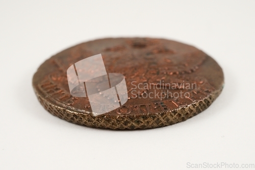 Image of edge of an old Russian copper coin of the 18th century on white 