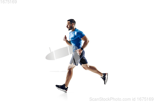 Image of Caucasian professional male runner, athlete training isolated on white studio background. Copyspace for ad.