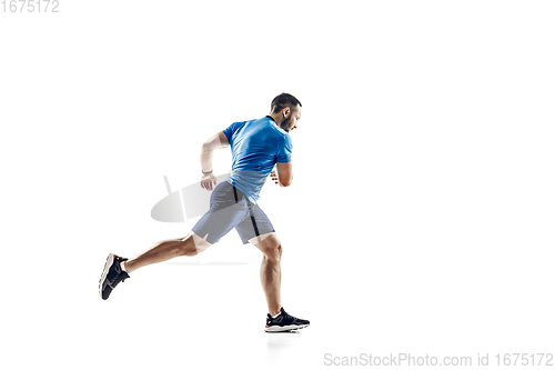 Image of Caucasian professional male runner, athlete training isolated on white studio background. Copyspace for ad.