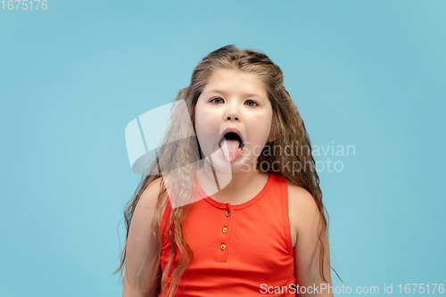 Image of Happy caucasian little girl isolated on studio background. Looks happy, cheerful, sincere. Copyspace. Childhood, education, emotions concept