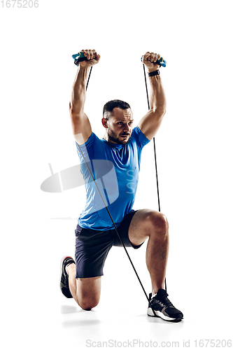 Image of Caucasian professional male runner, athlete training isolated on white studio background. Copyspace for ad.