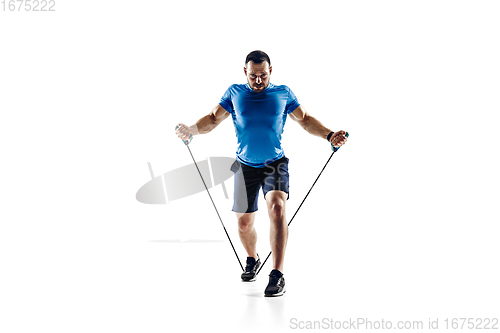 Image of Caucasian professional male runner, athlete training isolated on white studio background. Copyspace for ad.