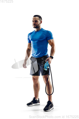 Image of Caucasian professional male runner, athlete training isolated on white studio background. Copyspace for ad.