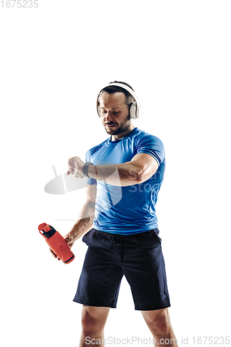 Image of Caucasian professional male runner, athlete training isolated on white studio background. Copyspace for ad.