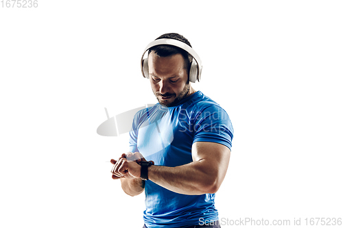 Image of Caucasian professional male runner, athlete training isolated on white studio background. Copyspace for ad.
