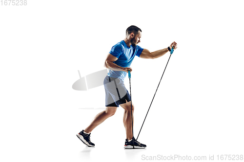 Image of Caucasian professional male runner, athlete training isolated on white studio background. Copyspace for ad.