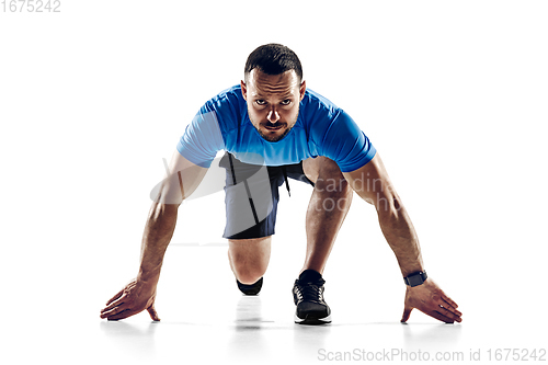 Image of Caucasian professional male runner, athlete training isolated on white studio background. Copyspace for ad.