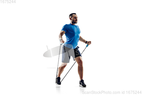 Image of Caucasian professional male runner, athlete training isolated on white studio background. Copyspace for ad.