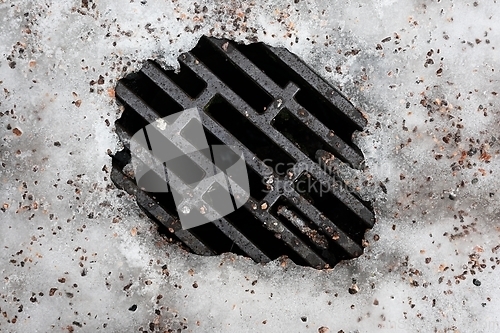 Image of storm sewer manhole with ice 