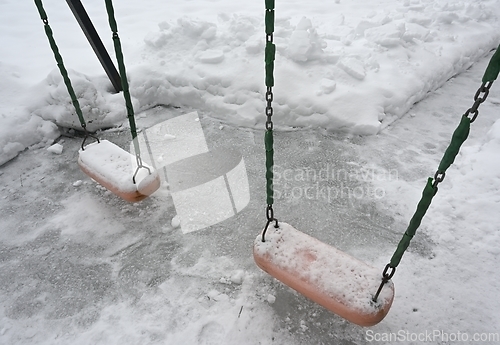 Image of swing on the playground in the yard in winter