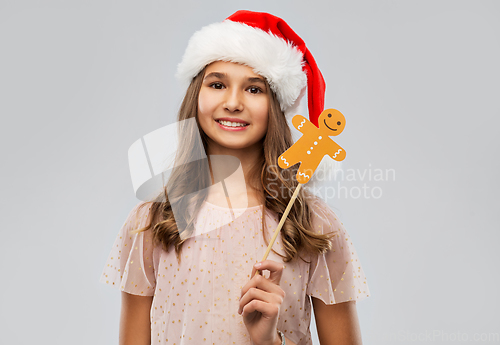 Image of happy teenage girl in santa hat on christmas