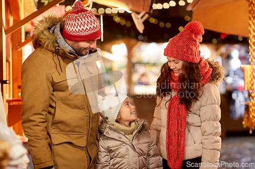 Image of happy family at christmas market in city