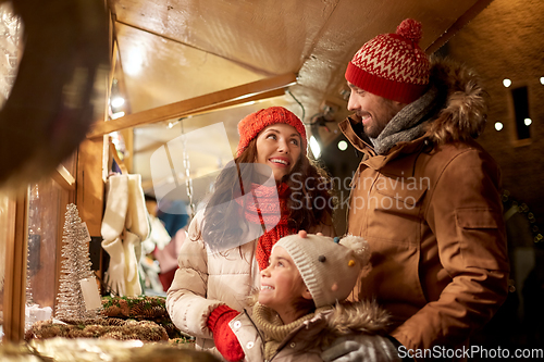 Image of happy family at christmas market in city