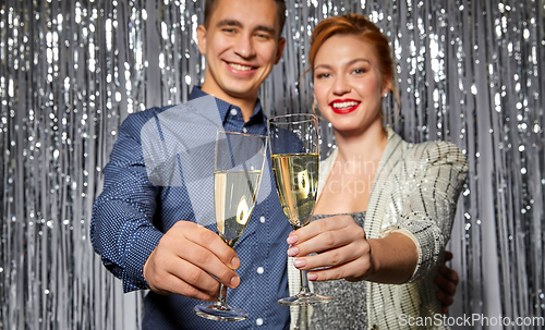 Image of couple with champagne glasses at christmas party