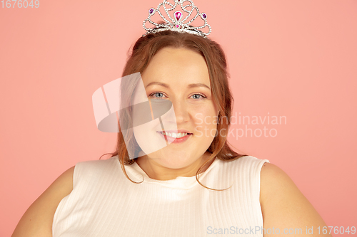 Image of Beautiful caucasian plus size model isolated on pink studio background. Concept of inclusion, human emotions, facial expression