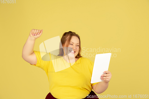 Image of Beautiful caucasian plus size model isolated on yellow studio background. Concept of inclusion, human emotions, facial expression