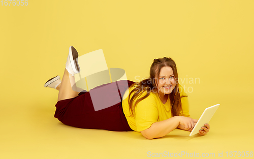 Image of Beautiful caucasian plus size model isolated on yellow studio background. Concept of inclusion, human emotions, facial expression