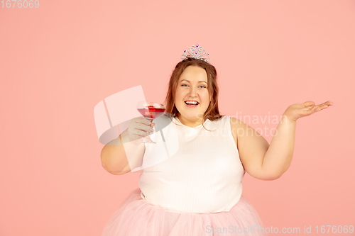 Image of Beautiful caucasian plus size model isolated on pink studio background. Concept of inclusion, human emotions, facial expression