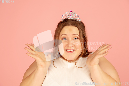 Image of Beautiful caucasian plus size model isolated on pink studio background. Concept of inclusion, human emotions, facial expression