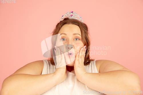 Image of Beautiful caucasian plus size model isolated on pink studio background. Concept of inclusion, human emotions, facial expression