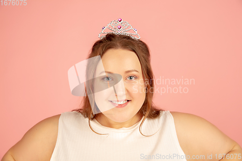 Image of Beautiful caucasian plus size model isolated on pink studio background. Concept of inclusion, human emotions, facial expression
