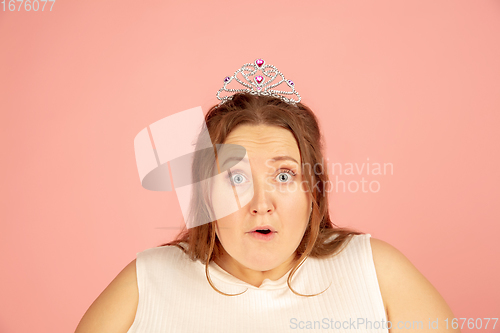 Image of Beautiful caucasian plus size model isolated on pink studio background. Concept of inclusion, human emotions, facial expression