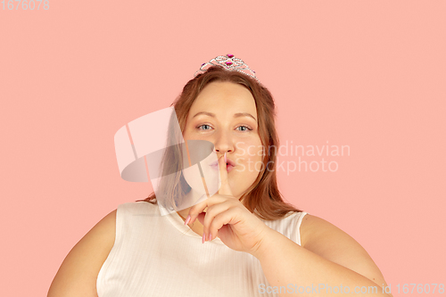 Image of Beautiful caucasian plus size model isolated on pink studio background. Concept of inclusion, human emotions, facial expression