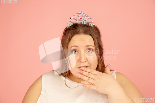 Image of Beautiful caucasian plus size model isolated on pink studio background. Concept of inclusion, human emotions, facial expression