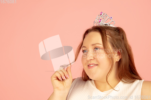 Image of Beautiful caucasian plus size model isolated on pink studio background. Concept of inclusion, human emotions, facial expression