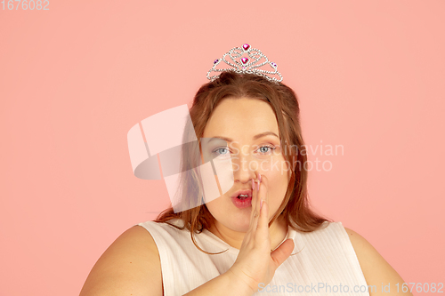 Image of Beautiful caucasian plus size model isolated on pink studio background. Concept of inclusion, human emotions, facial expression