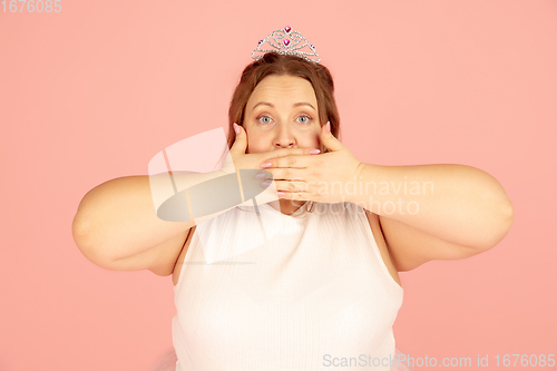 Image of Beautiful caucasian plus size model isolated on pink studio background. Concept of inclusion, human emotions, facial expression